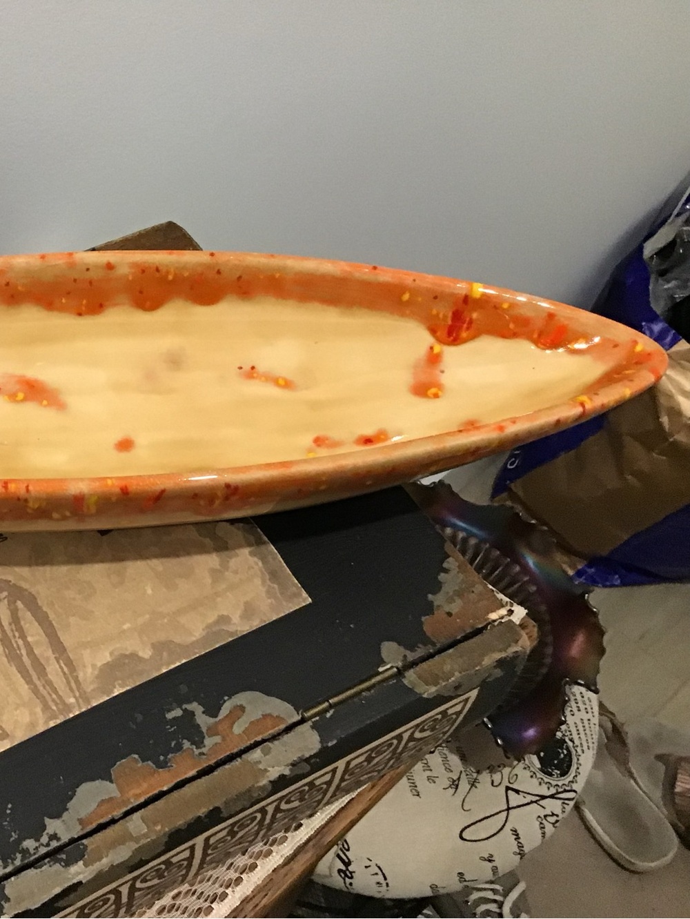 (300) Vintage MCM studio piece. Oblong orange and cream shiny glaze